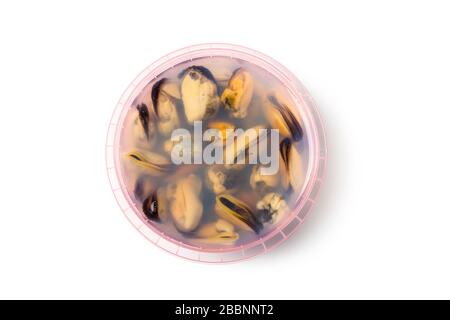 Marinated mussels in brine in a plastic jar isolated on white Stock Photo