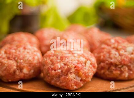 Raw meat balls on the wooden cutboard Stock Photo