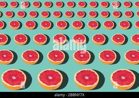 Tasty ripe grapefruit slices on blue background, flat lay Stock Photo