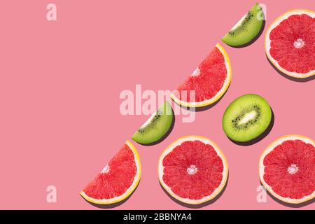 Seamless pattern with fruits. Tropical abstract pink background with kiwi and greapfruit with copyspace Stock Photo