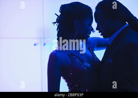 Young couple dance close together in a nightclub. Stock Photo