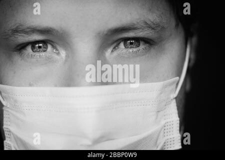 Young white man wears a medical mask during quarantine at his home, Bogotá, April 1, 2020 Stock Photo