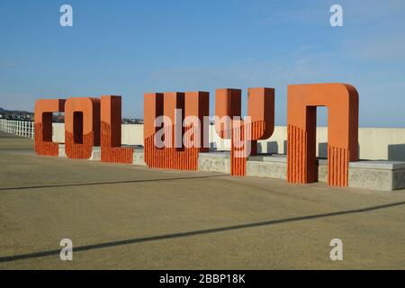 Large sign reading Colwyn in large letters on the sea front at Colwyn Bay in North Wales Stock Photo