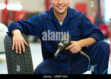 Mechanic working in auto repair shop Stock Photo
