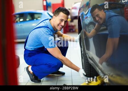 Mechanic working in auto repair shop Stock Photo