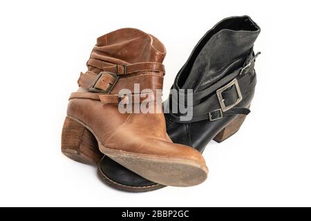 Mismatched   used brown and back leather boots isolated on a white background. Stock Photo