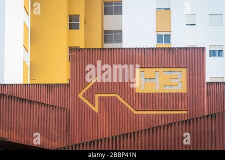urban concrete block of flats with painted arrow on the wall. Stock Photo