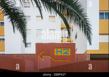 Urban concrete block of flats with painted arrow on the wall. Stock Photo