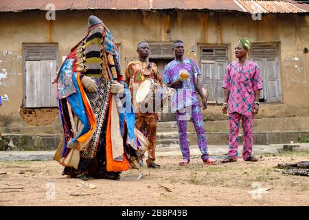 Man dressed with an Egungun mask performing during a ritual dance. The Egungun is a Yoruba character that represents the ancestors in the religious ce Stock Photo