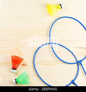 Sports flat lay with shuttlecock and badminton racket, skipping rope,  sneakers and measuring tape on green background. Fitness, sport and healthy  lifestyle concept. Stock Photo