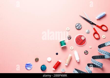 Sewing tools and accessories layout on pink background, top view Stock Photo