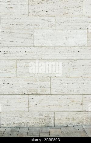 Travertine facade as background with a small piece of travertine stone floor Stock Photo