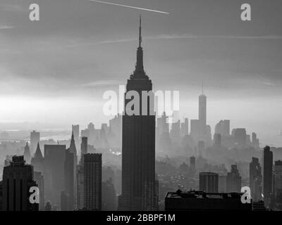 Manhattan skyline - a hazy view of downtown Manhattan from the Empire State Building to One World Trade Center. Stock Photo