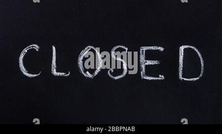 Drawing with chalk on a black blackboard, handwritten text closed Stock Photo