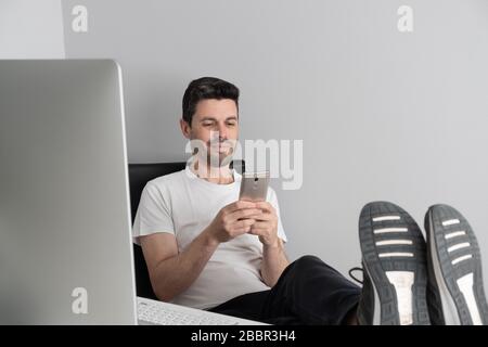 a man works relaxed from home Stock Photo