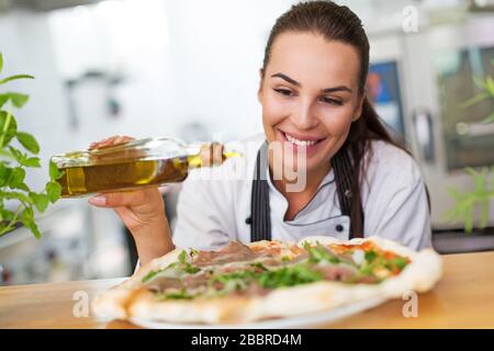 Female chef in kitchen Stock Photo