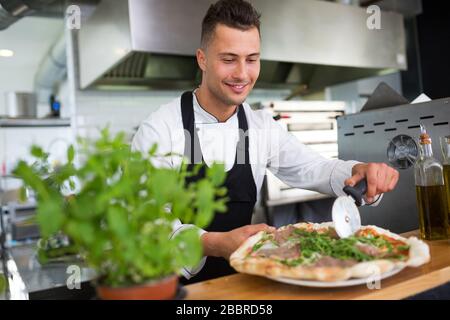 Professional chef in industrial kitchen Stock Photo