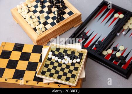 Board games on the table. Chess, backgammon, checkers. Boards are laid out for the game. Play, have fun at home. Leisure, hobbies. Stock Photo