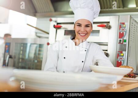Female chef in kitchen Stock Photo