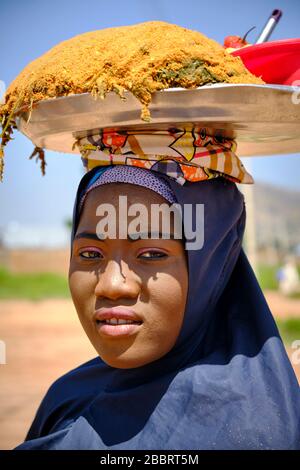 Portrait of a young muslim woman  with make up selling food in a street market. Stock Photo