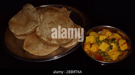 Bengali Luchi with Mutter Paneer. Cottage chese with pea dish and Indian Poori. Bengali food, Indian food, Indian dish, Bengali dish Stock Photo