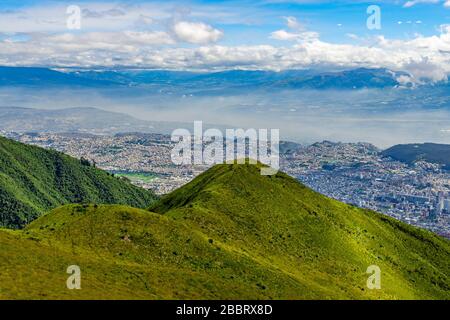 Aerial view from the cityscape of Quito city skyscrapers seen from the Pichincha Volcano, Ecuador. Stock Photo