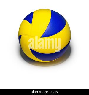 Closeup yellow blue volleyball sports equipment with light shining from above, with shadow below, isolated leather volley ball object on a square whit Stock Photo