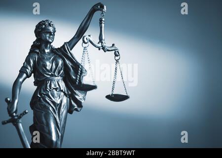 Figure of Justice holding scales and a sword Stock Photo