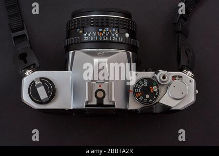Old analogue classic Pentax MX 35mm camera viewed from above, on black background Stock Photo