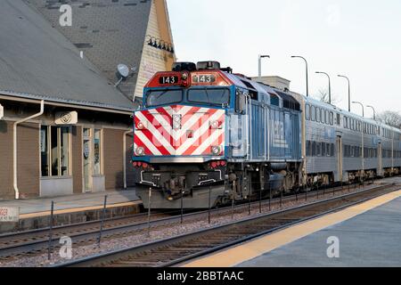 Geneva, Illinois, USA. A Metra locomotive pushing its commuter train destined for Chicago as it departs the depot in Geneva, Illinois.
