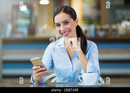 Young businesswoman working at cafe Stock Photo
