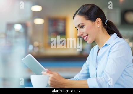 Young businesswoman working at cafe Stock Photo