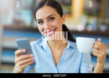 Young businesswoman working at cafe Stock Photo