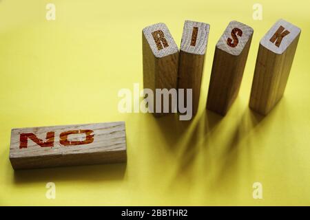 No risk wotds on wooden blocks. Investment risky assets financial instruments concept Stock Photo