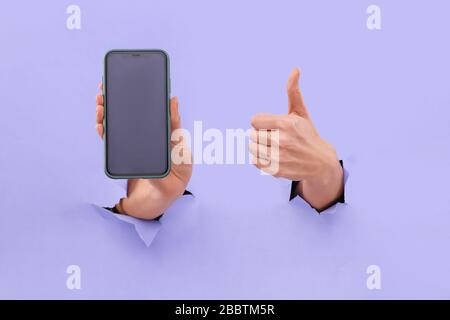 Like and smartphone. Copy space on the smartphone screen, in trendy blue. Stock Photo