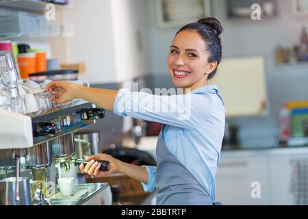 Female barista making coffee Stock Photo