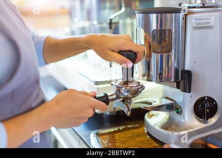 Female barista making coffee Stock Photo