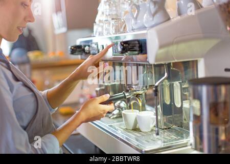 Female barista making coffee Stock Photo