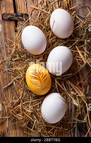 Easter painted chicken golden egg Stock Photo