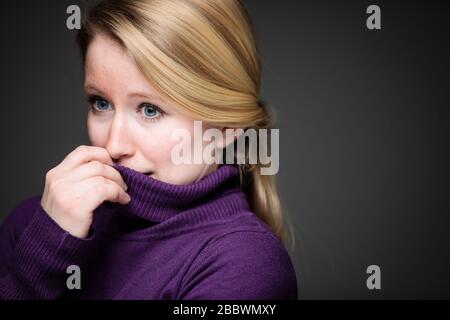 Fear/anxiety/regret/uncertainty in a young woman - effects of a difficult life situation - vivid emotions concept Stock Photo