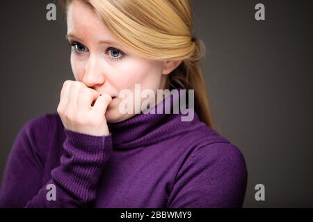 Fear/anxiety/regret/uncertainty in a young woman - effects of a difficult life situation - virus pandemic/confinement concept Stock Photo