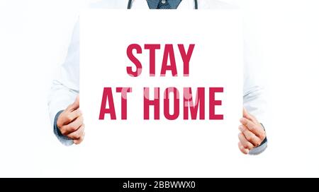 Concept of coronavirus quarantine. 2019-nCoV. Doctor is writing the word stay at home. Stock Photo