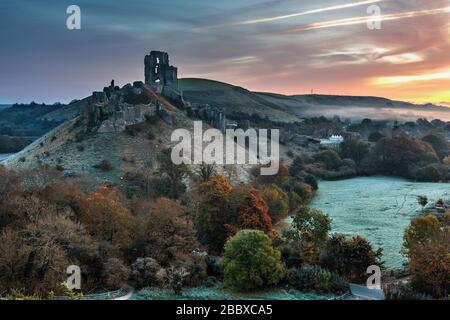 Sunrise on a frosty November morning at Corfe Castle in Dorset, England Stock Photo