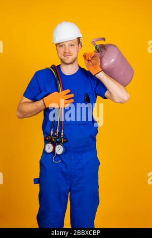 Air conditioning technician. air conditioning repair and pressure gauges, measuring equipment for filling air conditioners. Stock Photo