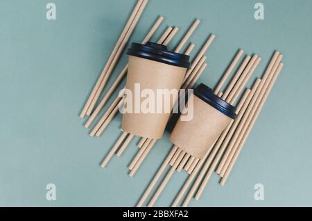 Craft coffee cups with paper straw on gray background. Eco friendly design. Zero waste, plastic free items Stock Photo
