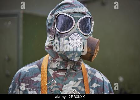 Mannequin dressed in a special camouflage suit and gas mask.