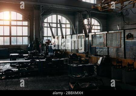 Old abandoned railroad workshop. Train repairing factory with old machinery. Stock Photo