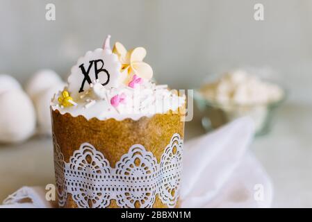 Easter composition with orthodox sweet bread, kulich and eggs on light background. Easter holidays breakfast concept with copy space. Stock Photo