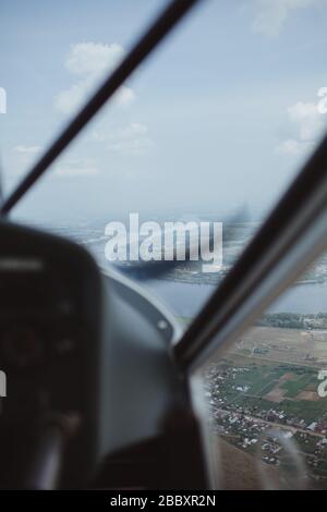 view from the cockpit of a flying small plane Stock Photo