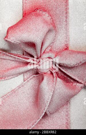 large red bow in silver on a gift box. Stock Photo
